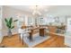 Dining room with modern light fixture, a wooden table set for four, and stylish accent pieces at 2515 W Club Blvd, Durham, NC 27705