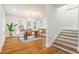 Dining area with a wooden table, stylish chairs, and open flow to the staircase and updated kitchen at 2515 W Club Blvd, Durham, NC 27705