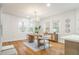 Inviting dining area featuring hardwood floors, a modern light fixture, and view to kitchen at 2515 W Club Blvd, Durham, NC 27705