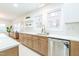 Bright kitchen with white cabinets, marble countertops, stainless steel appliances, and light brown cabinets below the counter at 2515 W Club Blvd, Durham, NC 27705