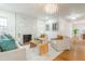 Bright living room boasts a marble fireplace, chandelier, and hardwood floors at 2515 W Club Blvd, Durham, NC 27705