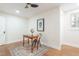 Home office features a rustic desk, patterned rug, and natural light from the window at 2515 W Club Blvd, Durham, NC 27705