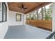 Covered porch with a wooden ceiling, ceiling fan, and painted brick, perfect for outdoor relaxation at 2515 W Club Blvd, Durham, NC 27705