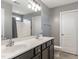 Bright bathroom featuring double sinks, a large mirror, and a shower-tub combination at 2605 Mcdougall Dr, Burlington, NC 27217