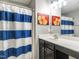 Stylish bathroom featuring a vanity with a sink, mirror and a shower-tub with stylish curtain at 2605 Mcdougall Dr, Burlington, NC 27217