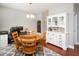 Cozy dining room combined with a home office, with hardwood floors and accent furniture at 2605 Mcdougall Dr, Burlington, NC 27217