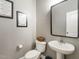 Cozy half bathroom with updated fixtures and decorative wall art at 2605 Mcdougall Dr, Burlington, NC 27217