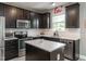 Modern kitchen featuring stainless steel appliances, white subway tile backsplash, and a center island at 2605 Mcdougall Dr, Burlington, NC 27217