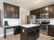 Modern kitchen featuring dark wood cabinets, stainless steel appliances, and a center island at 2605 Mcdougall Dr, Burlington, NC 27217