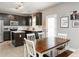 Spacious kitchen with dark wood cabinets, an island, and an adjacent dining area for casual meals at 2605 Mcdougall Dr, Burlington, NC 27217