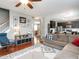 Bright and airy living room featuring hardwood floors, a sectional sofa, and open access to the kitchen at 2605 Mcdougall Dr, Burlington, NC 27217