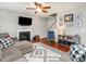 Comfortable living room with a fireplace, hardwood floors and a ceiling fan, perfect for relaxing at 2605 Mcdougall Dr, Burlington, NC 27217