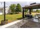 Outdoor covered seating area in the backyard with string lights and view to the backyard at 2605 Mcdougall Dr, Burlington, NC 27217