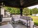 Inviting outdoor seating area under a covered pavilion, overlooking a private backyard at 2605 Mcdougall Dr, Burlington, NC 27217