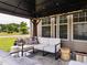 Covered outdoor patio with seating, a stylish aesthetic and a view to the front yard at 2605 Mcdougall Dr, Burlington, NC 27217
