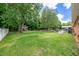 Expansive backyard with mature trees, a playset, and ample space to relax at 2824 Blanche Dr, Burlington, NC 27215