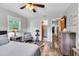 Bright bedroom with hardwood floors, ceiling fan, and view into the Primary bath at 2824 Blanche Dr, Burlington, NC 27215