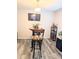 Dining area boasting a high-top table, chairs, a modern light fixture and adjacent to living room at 2824 Blanche Dr, Burlington, NC 27215