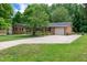 Charming one-story brick home featuring a well-maintained lawn, mature trees, and an attached garage at 2824 Blanche Dr, Burlington, NC 27215