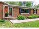 Inviting front entrance showcasing a brick facade, decorative door, and well-manicured landscaping at 2824 Blanche Dr, Burlington, NC 27215