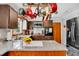 Well-lit kitchen with stainless steel appliances, granite countertops, and hanging pot rack at 2824 Blanche Dr, Burlington, NC 27215