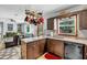 Bright kitchen with stainless steel appliances, ample counter space, and an open layout to the living room at 2824 Blanche Dr, Burlington, NC 27215