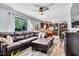 Inviting living room open to kitchen area, featuring comfortable leather furniture and natural light at 2824 Blanche Dr, Burlington, NC 27215