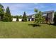 This fenced in backyard features a play-set and well manicured lawn at 310 Seymour Pl, Cary, NC 27519