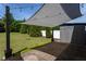 Backyard patio with awning, pavers, green lawn, and privacy fence creates a serene outdoor living space at 310 Seymour Pl, Cary, NC 27519