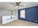 This loft bedroom has a ceiling fan, a window for light, and blue accent wall at 310 Seymour Pl, Cary, NC 27519