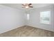 This bedroom features neutral carpeting, two windows for natural light, and a ceiling fan at 310 Seymour Pl, Cary, NC 27519