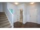 Spacious foyer featuring hard wood floors, a staircase, and multiple entryways at 310 Seymour Pl, Cary, NC 27519