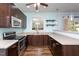 Kitchen with stainless steel appliances, dark cabinetry and view to back yard at 310 Seymour Pl, Cary, NC 27519