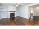 Living room featuring hardwood floors, a fireplace and built in shelving at 310 Seymour Pl, Cary, NC 27519