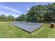 Community playground featuring swings and a soft, safe play surface surrounded by green space at 310 Seymour Pl, Cary, NC 27519