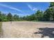 Sand volleyball court with a net and trees provides a fun recreational area for residents at 310 Seymour Pl, Cary, NC 27519