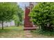 Lush backyard featuring a stairway to the second story and green landscaping at 312 Green St, Sanford, NC 27330