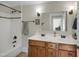 Bathroom featuring double sinks and a tub/shower with white tiled walls at 312 Green St, Sanford, NC 27330
