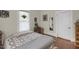 Bedroom with wood floors, decor items, and a view through a window at 312 Green St, Sanford, NC 27330