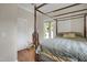 Cozy bedroom with hardwood floors, a four-poster bed, and natural light from the window at 312 Green St, Sanford, NC 27330