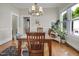 Bright dining room boasts a chandelier, wood table, and large windows that fill the space with natural light at 312 Green St, Sanford, NC 27330