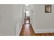 Hallway view with hardwood flooring leading to a light-filled room with indoor plants at 312 Green St, Sanford, NC 27330
