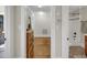 View of hallway leading to a bathroom, featuring wood floors, and access to another room at 312 Green St, Sanford, NC 27330