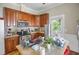 A well-lit kitchen featuring wood cabinets, stainless steel appliances, and tiled countertops at 312 Green St, Sanford, NC 27330