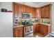 A kitchen with wood cabinets, stainless steel appliances, and a tiled backsplash at 312 Green St, Sanford, NC 27330