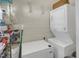 Functional laundry room featuring a stacked washer and dryer, plus freezer, for added convenience at 312 Green St, Sanford, NC 27330
