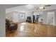 Open living room with hardwood floors leads to the kitchen with laundry machines at 312 Green St, Sanford, NC 27330
