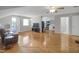 Open living room with hardwood floors leads to the kitchen with laundry machines at 312 Green St, Sanford, NC 27330