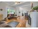 Spacious living room with hardwood floors, a white fireplace, and views into other rooms at 312 Green St, Sanford, NC 27330