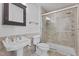 Tiled bathroom with glass-enclosed shower, dark wood mirror cabinet, and pedestal sink at 320 W Martin St # 205, Raleigh, NC 27601